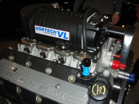 1998 Ford Crown Victoria - Close-up of a Vortech VL supercharger installed on a Ford SVT engine, "POWERED BY SVT" branding.