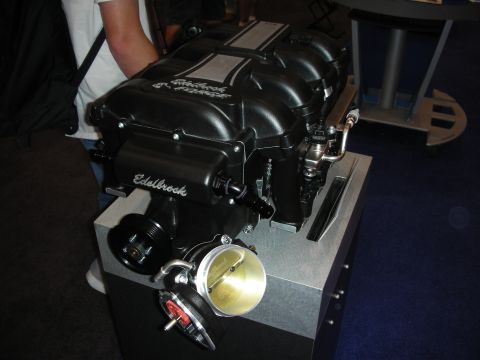 1998 Ford Crown Victoria - Close-up of an Edelbrock supercharger assembly, likely on display at an event.