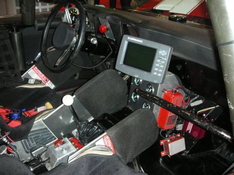 1998 Ford Crown Victoria - The interior of a race car features racing seats, a roll cage, and a Lowrance GPS unit.