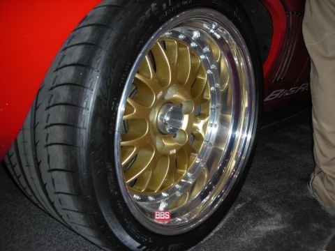 1998 Ford Crown Victoria - Close-up of a gold BBS wheel with a polished lip on a red vehicle.