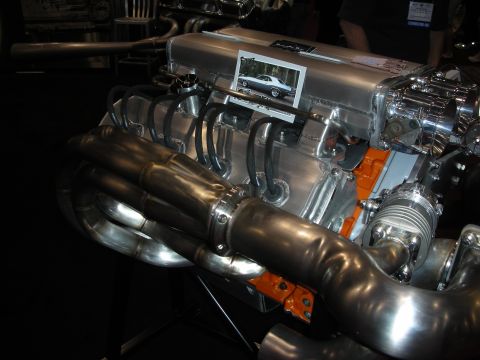 1998 Ford Crown Victoria - A close-up view of a highly customized V8 engine, polished metal components and a turbocharger.