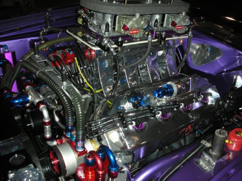 1998 Ford Crown Victoria - This engine bay is packed with custom parts and vibrant purple paint.