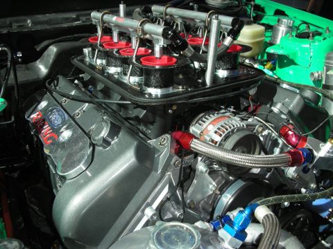 1998 Ford Crown Victoria - A highly modified V8 engine is shown with custom fuel rails and an alternator, indicating performance upgrades.