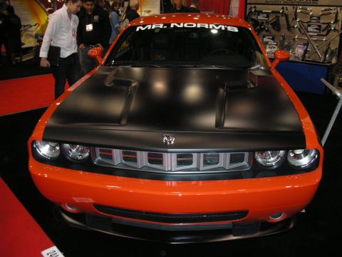 1998 Ford Crown Victoria - This orange Dodge Challenger features a matte black hood and a prominent grille.