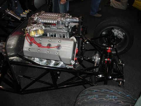 1998 Ford Crown Victoria - Custom hot rod chassis with a supercharged V8 engine and front suspension components visible.