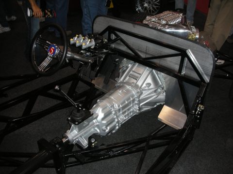 1998 Ford Crown Victoria - Custom drag car chassis with a supercharged V8 engine and manual transmission is on display.