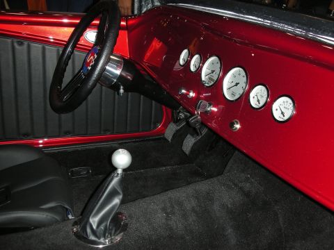 1998 Ford Crown Victoria - Interior view of a custom hot rod a red dash, gauges, and a floor shifter.
