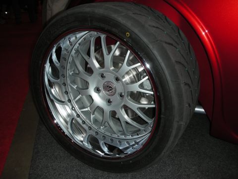 1998 Ford Crown Victoria - A custom wheel and tire assembly is shown on a red vehicle.