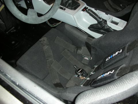 1998 Ford Crown Victoria - The interior of a car is shown, black racing seats and NRG harnesses.