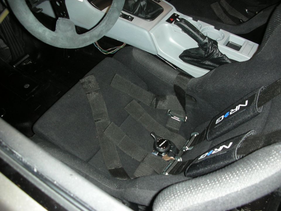 Interior view of car with black racing seats and NRG harnesses
