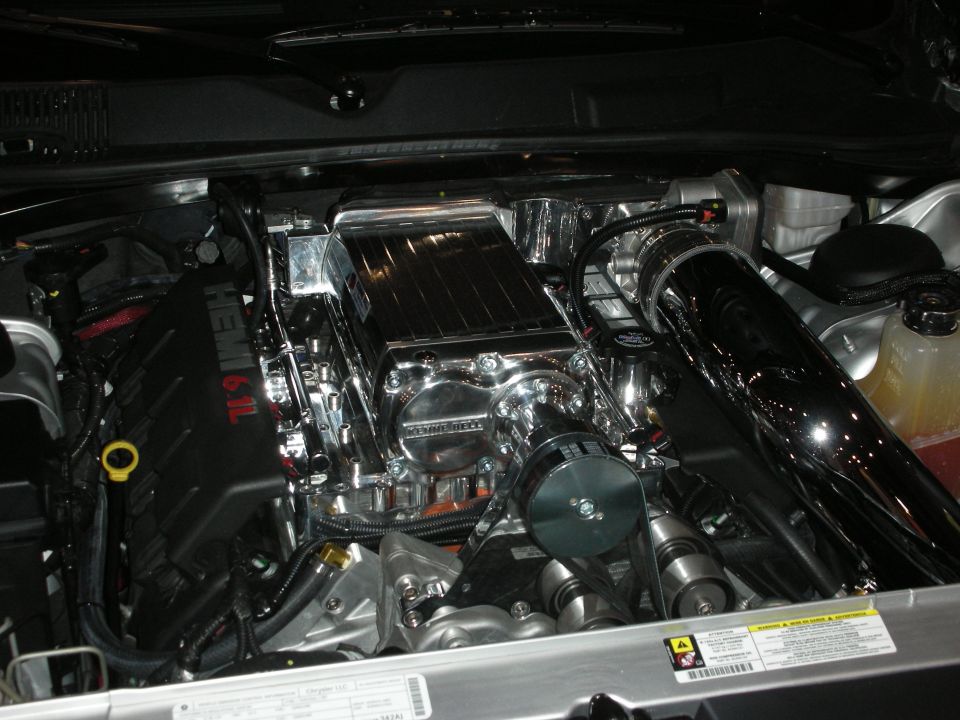 Engine bay with a supercharged 6.1L Hemi engine, chrome intake, and polished components