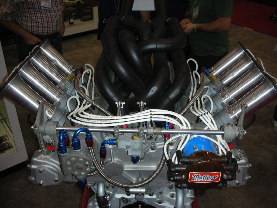 Engine with four silver intake stacks and black exhaust headers, Mallory Ignition distributor