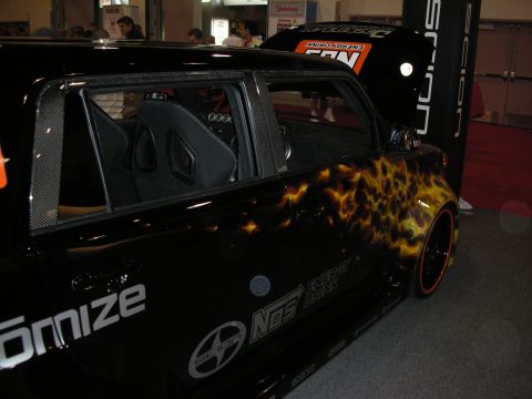 1998 Ford Crown Victoria - Customized Scion xB flame graphics and racing seats, seen at an event.