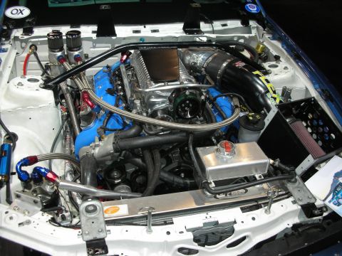 1998 Ford Crown Victoria - Custom V8 engine bay features a prominent supercharger and extensive modifications.