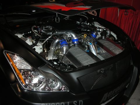 1998 Ford Crown Victoria - The engine bay of a car is open, revealing a complex setup with twin turbochargers and intercoolers.