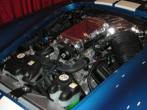 1998 Ford Crown Victoria - The engine bay features a prominent Kenne Bell Mammoth supercharger, indicating a high-performance setup.
