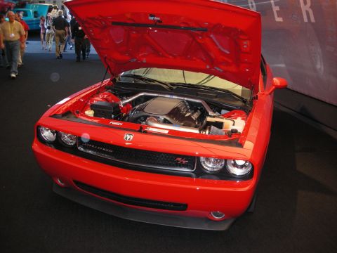 1998 Ford Crown Victoria - Red Dodge Challenger with its hood open, revealing the engine bay.