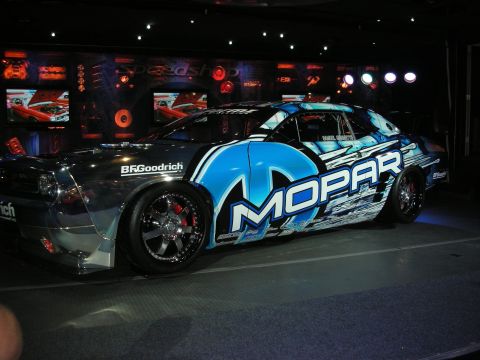 1998 Ford Crown Victoria - Custom Mopar car with unique livery and chrome accents displayed indoors.