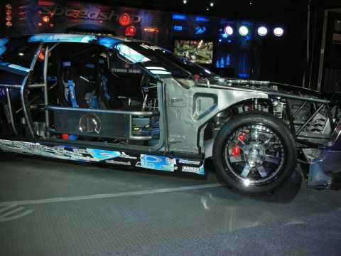 1998 Ford Crown Victoria - A heavily modified vehicle with racing modifications is displayed indoors.