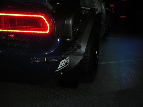 1998 Ford Crown Victoria - Rear view of a custom dark blue car a bright red LED taillight and quad exhaust pipes.