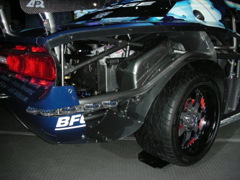 1998 Ford Crown Victoria - This custom race car features extensive modifications to its rear suspension and bodywork, with visible branding from Dodge and BFGoodrich.