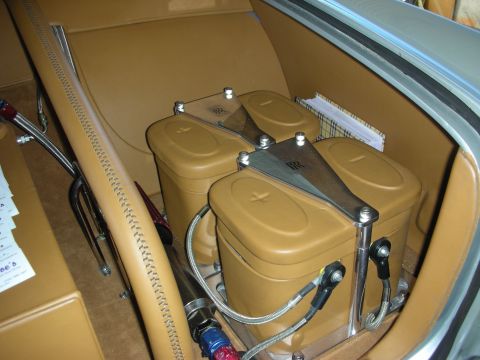 1998 Ford Crown Victoria - Custom components are installed in the tan interior of a car, with a visible RR logo on a bracket.