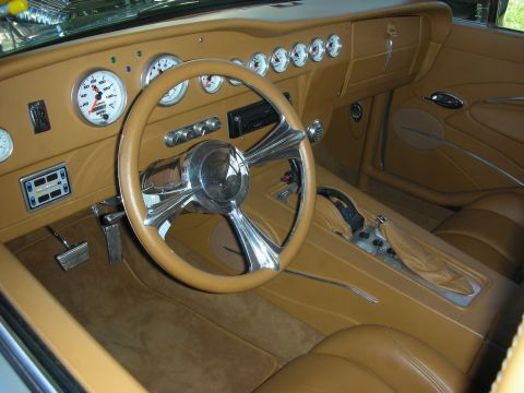 1998 Ford Crown Victoria - The custom tan interior features a chrome steering wheel and numerous aftermarket gauges on the dashboard.