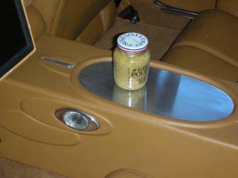 1998 Ford Crown Victoria - A jar of Grey Poupon mustard sits on the center console of a car's interior.