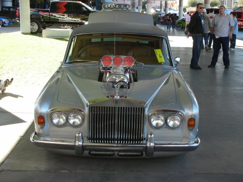 1998 Ford Crown Victoria - A heavily modified silver Rolls-Royce is displayed with its hood up, revealing a large supercharger.