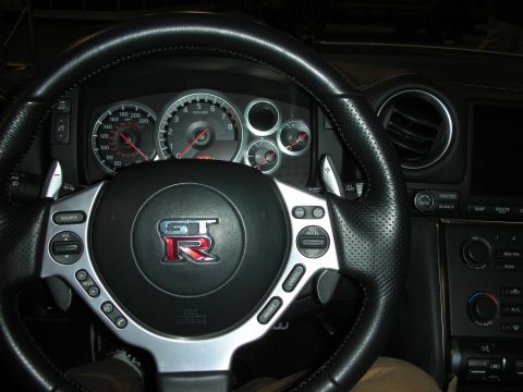 1998 Ford Crown Victoria - Interior view of a Nissan GT-R, showing the steering wheel, instrument cluster, and center console.