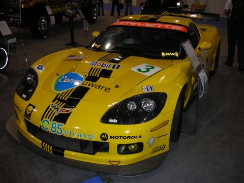 1998 Ford Crown Victoria - This yellow Corvette race car is covered in sponsor decals and has the number 3 on its hood.