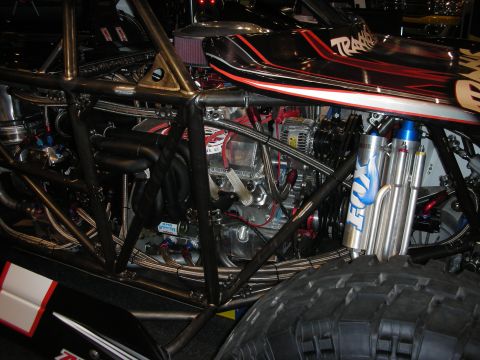 1998 Ford Crown Victoria - Close-up of a custom off-road buggy's engine and suspension system.