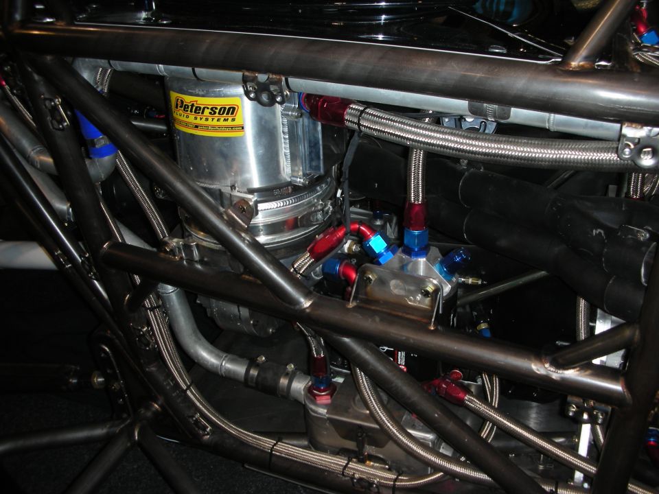 close-up of a Peterson Fluid Systems fuel pump and related plumbing in a custom race car chassis