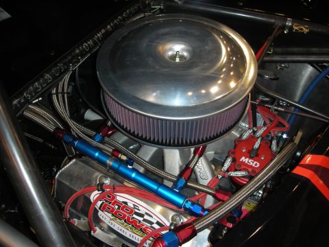 1998 Ford Crown Victoria - Close-up of a modified engine bay, showing custom fuel lines and ignition components.