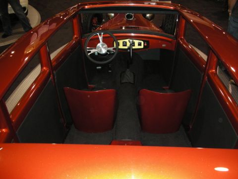 1998 Ford Crown Victoria - Interior view of a custom orange hot rod, red bucket seats and a unique steering wheel.