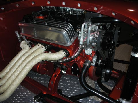 1998 Ford Crown Victoria - Close-up view of a modified V8 engine, custom components and heat-resistant exhaust wrapping.