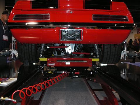 1998 Ford Crown Victoria - Rear view of a red 1969 Chevrolet Camaro, showing its suspension and exhaust system while on a lift.