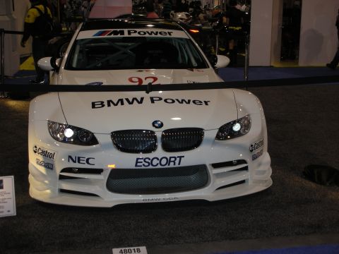 1998 Ford Crown Victoria - A white BMW M3 race car is displayed with "BMW Power" and "M Power" branding visible on its exterior.