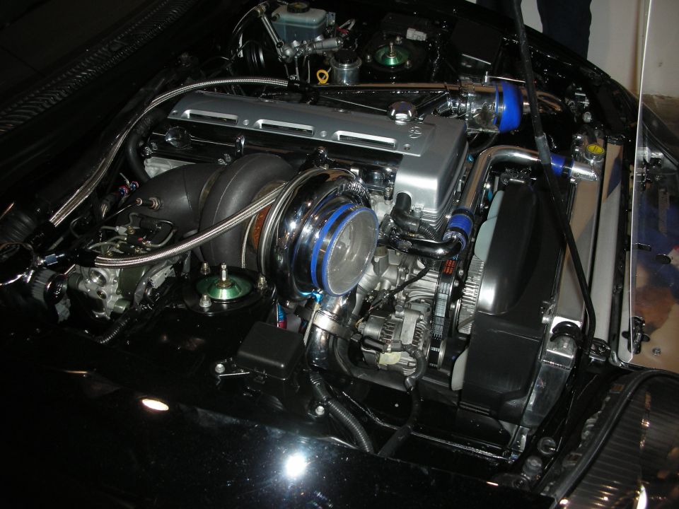 Engine bay with large chrome turbocharger and silver intake manifold