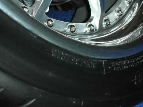 1998 Ford Crown Victoria - A close-up view of a tire and a custom chrome wheel, showing tire size information on the sidewall.