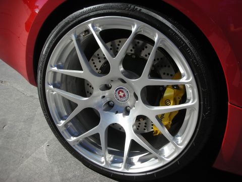 1998 Ford Crown Victoria - This image shows a close-up of a custom wheel and yellow brake caliper on a red vehicle.