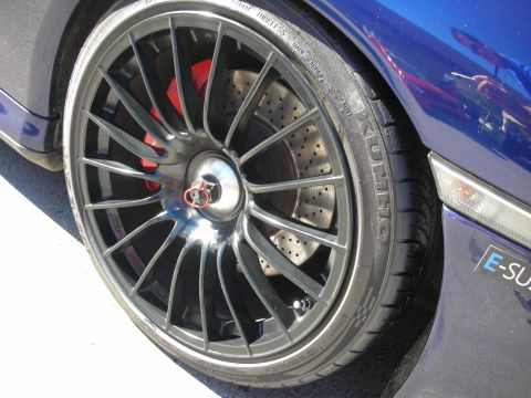 1998 Ford Crown Victoria - Detail shot of a performance wheel and brake system on a blue vehicle.