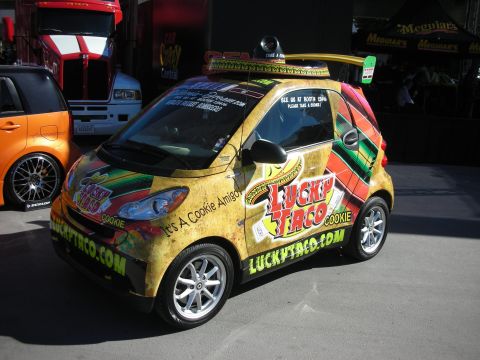 1998 Ford Crown Victoria - A Smart Fortwo is decorated with a 'Lucky Taco' theme and a sombrero on its roof.