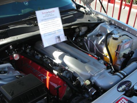 1998 Ford Crown Victoria - The engine bay of a car is shown with a sign detailing its modifications.