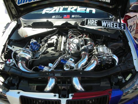 1998 Ford Crown Victoria - Modified engine bay with twin turbos and intercooler, a HRE Wheels sign.