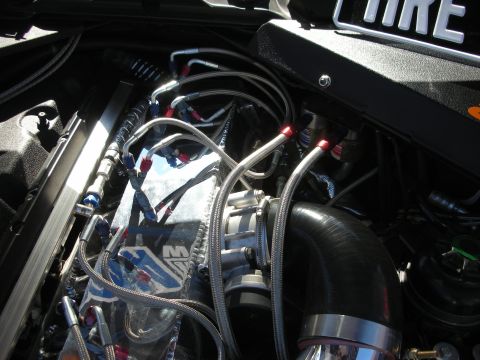 1998 Ford Crown Victoria - Custom engine bay modifications are visible, including braided fuel lines and a large intake pipe.