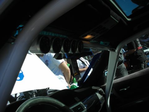 1998 Ford Crown Victoria - Interior view of a vehicle's cabin with a roll cage and multiple gauges installed.