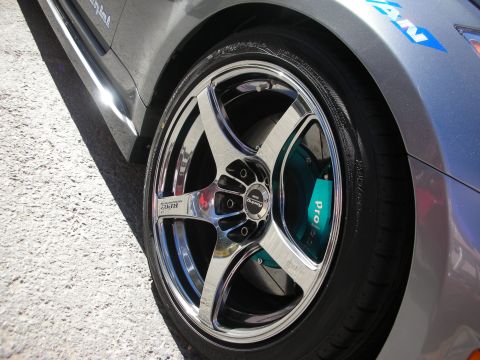 1998 Ford Crown Victoria - Close-up of a car's wheel and brake caliper, showing aftermarket modifications.