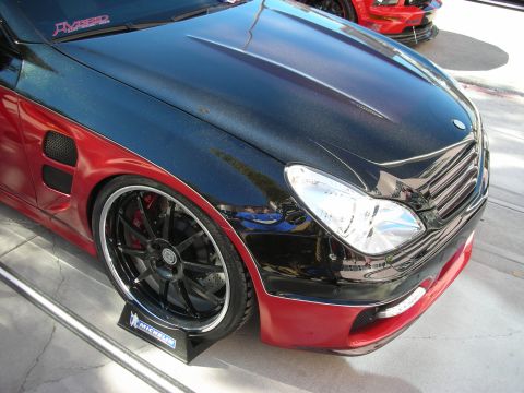 1998 Ford Crown Victoria - A customized car with a two-tone paint job and large aftermarket wheels is displayed.