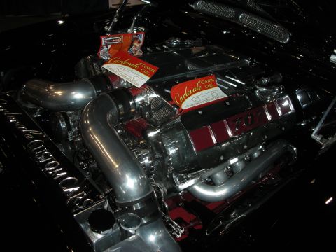 1998 Ford Crown Victoria - Custom engine bay with chrome details and two business cards from Carlervale Custom Cars.